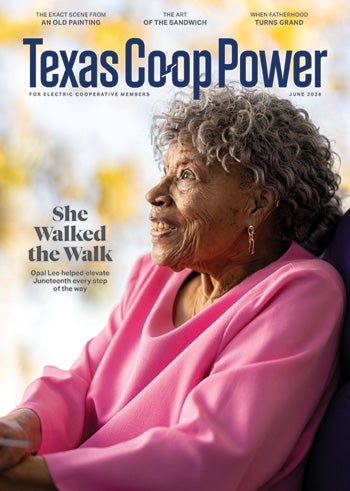 Texas Co-op Power Cover Magazine with A lady smiling in a pink sweater